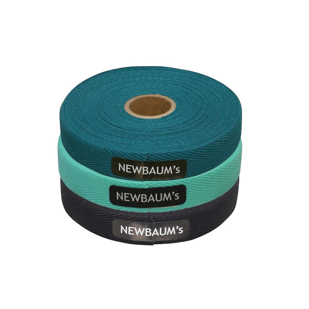Three rolls of Newbaum's tape on a white background