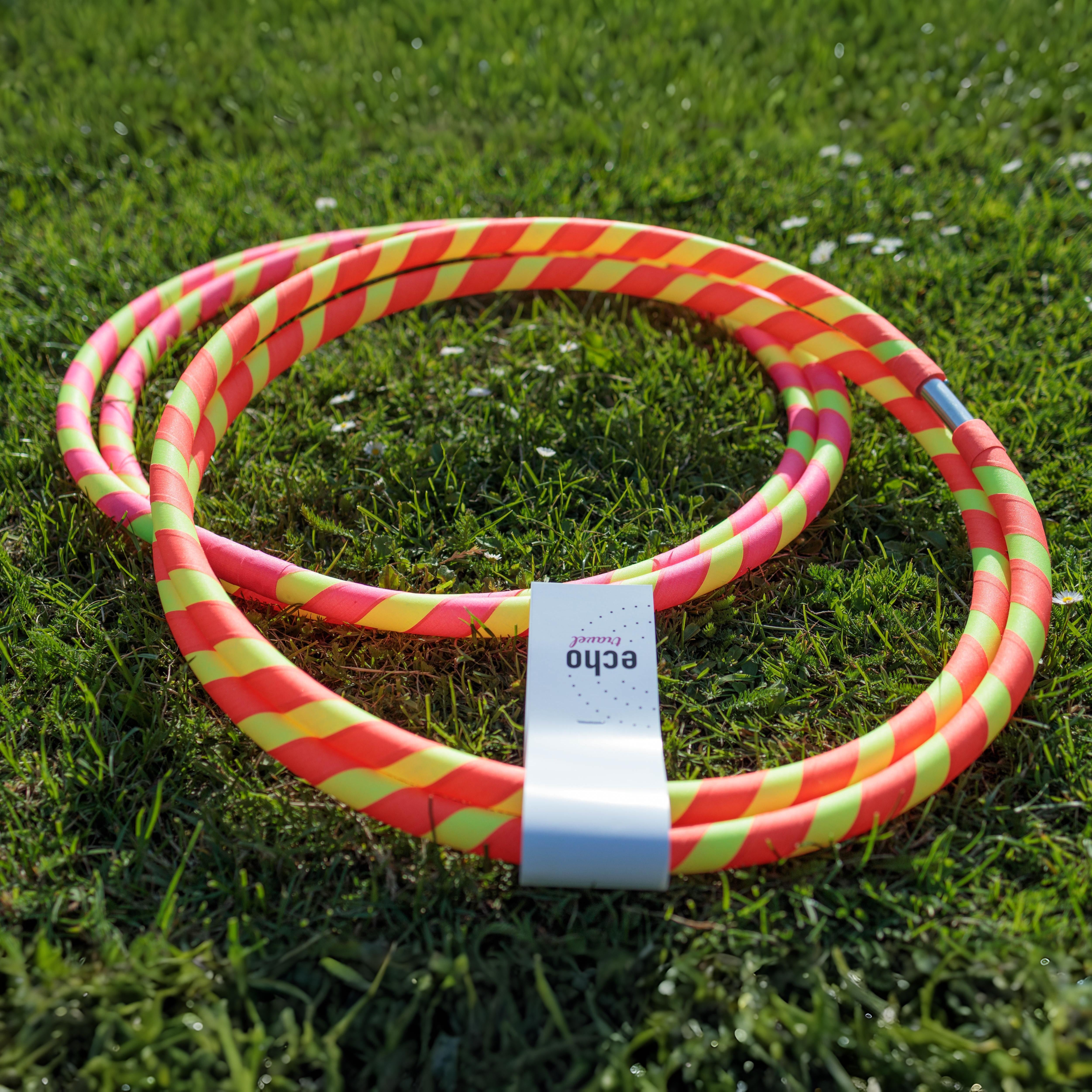 Two colorful hula hoops on grass