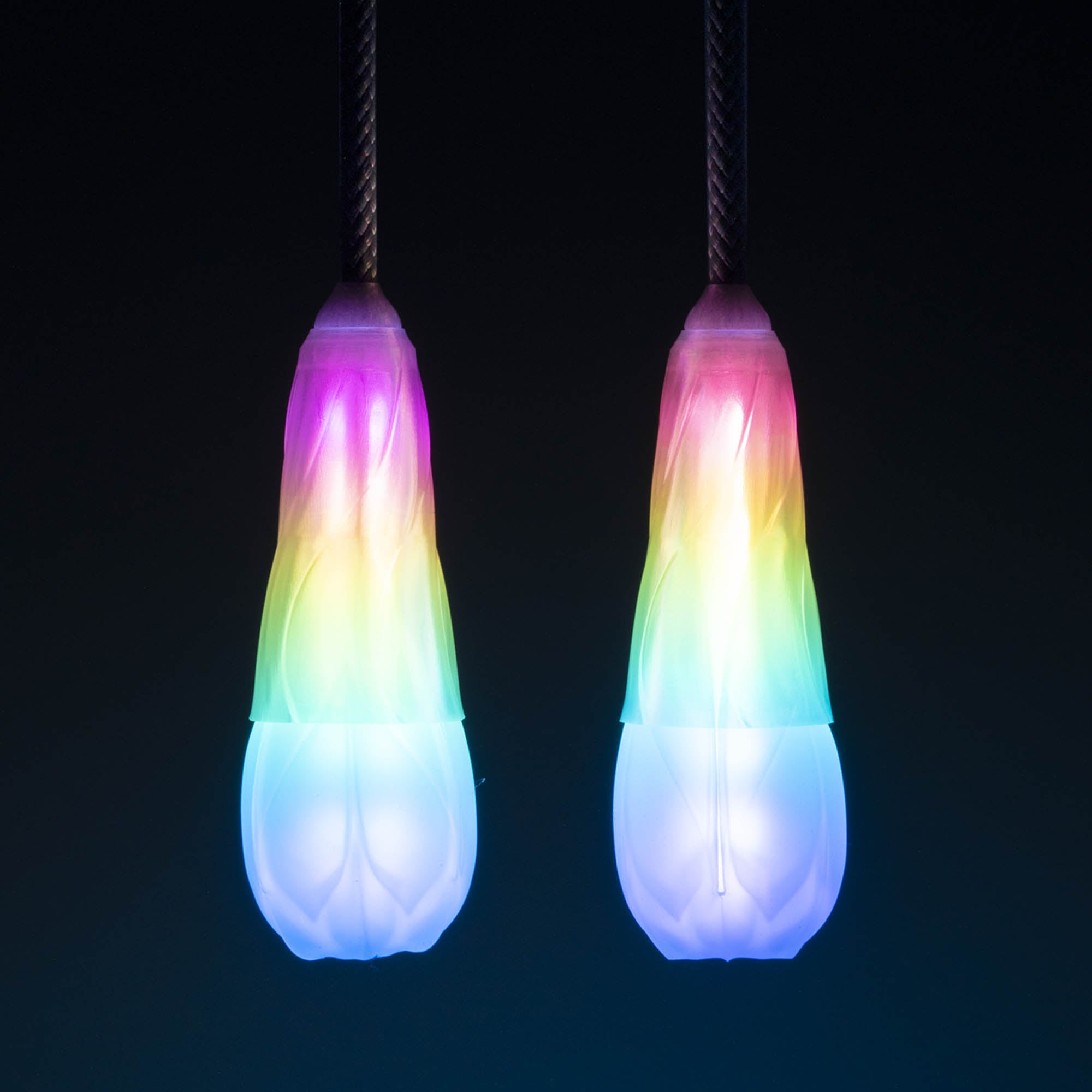 Flowtoys vision spin poi glowing with dark background whilst hanging