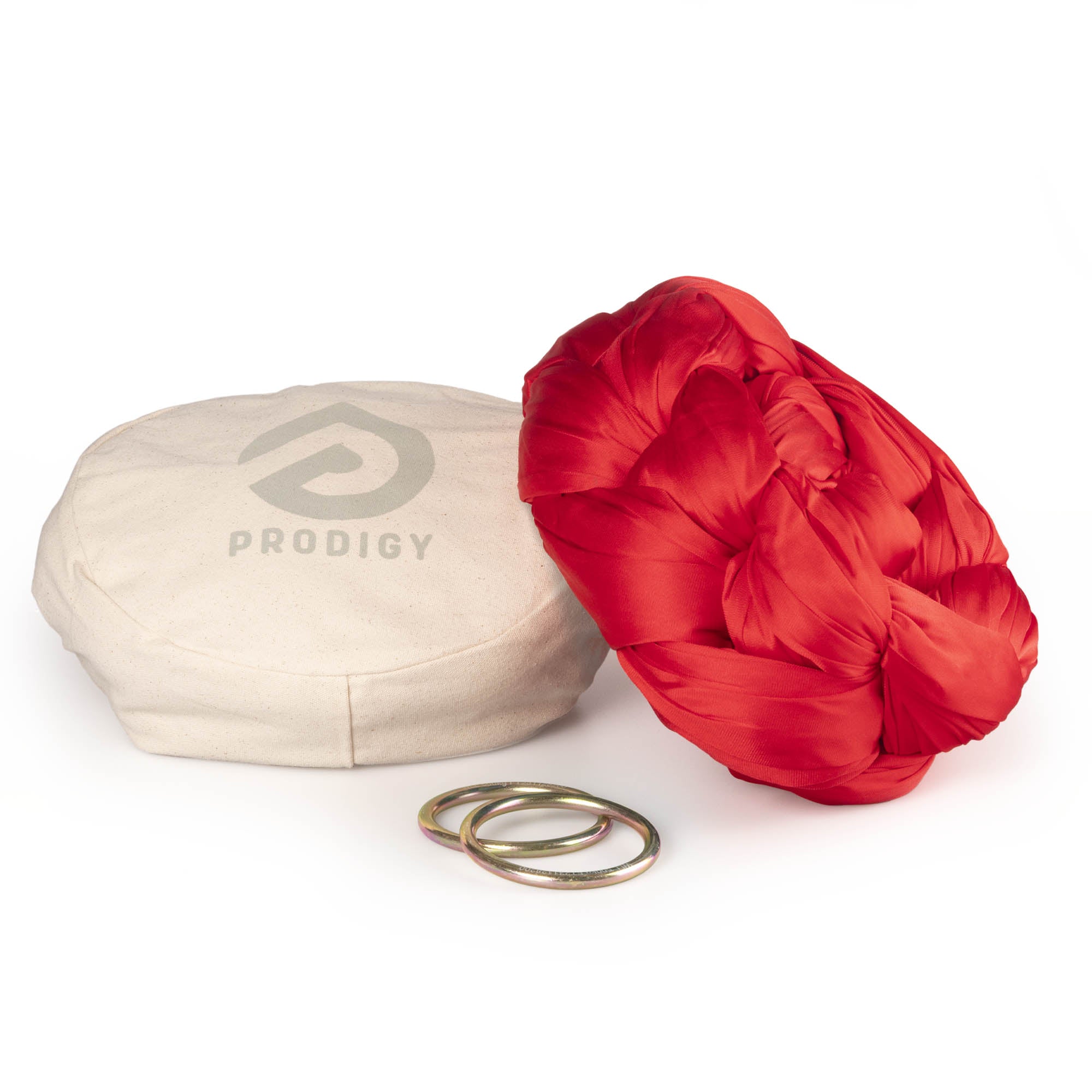 Red yoga hammock resting on eco bag with O-rings laying in front
