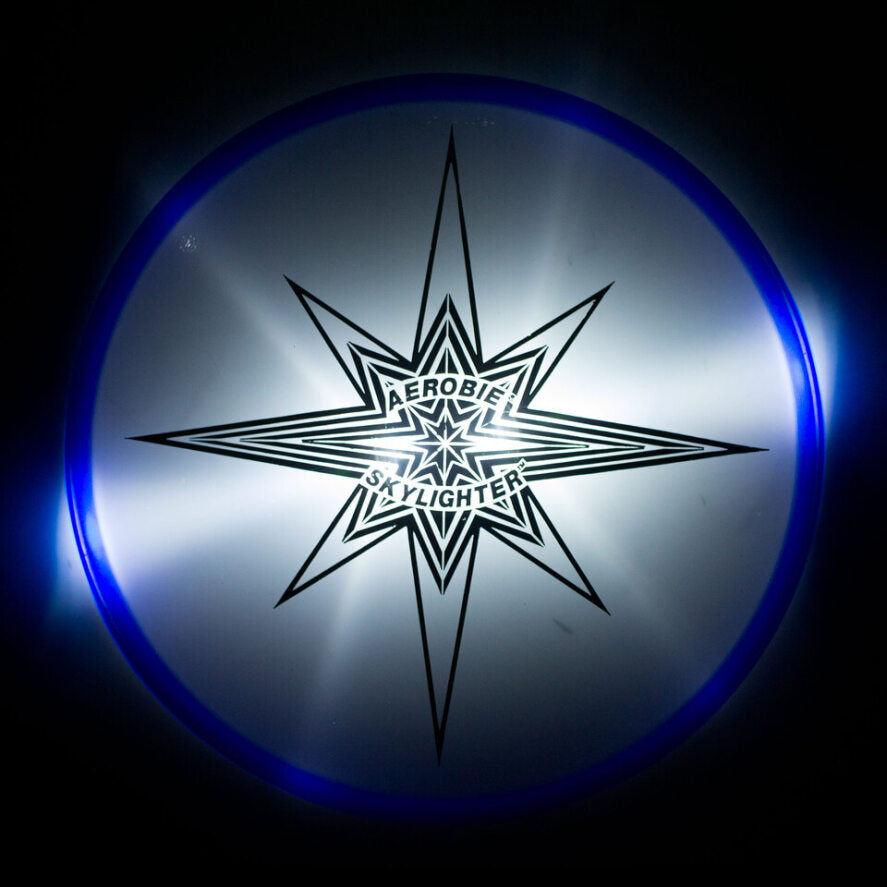 Aerobie skylighter blue lit on black background