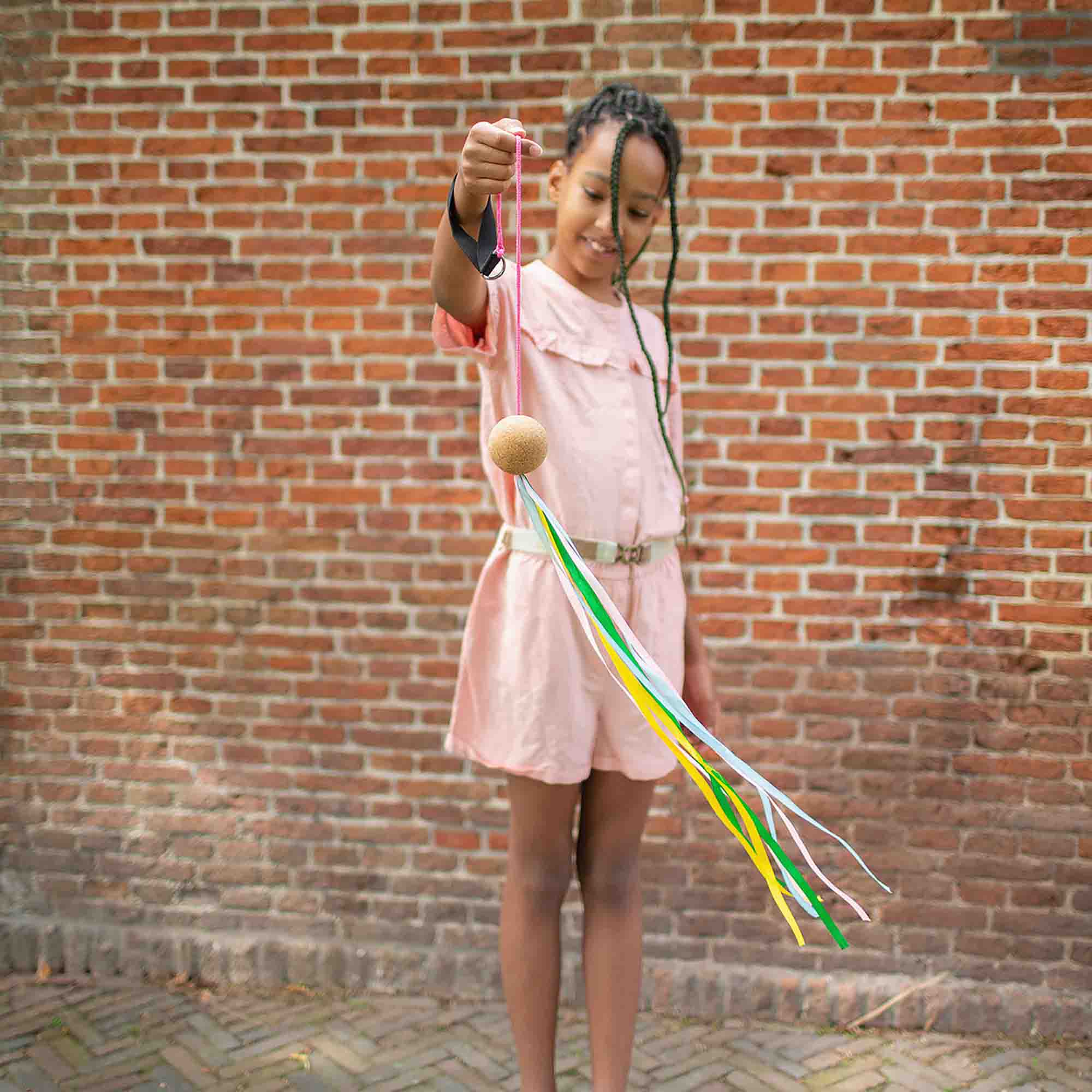 Young person using poi sling