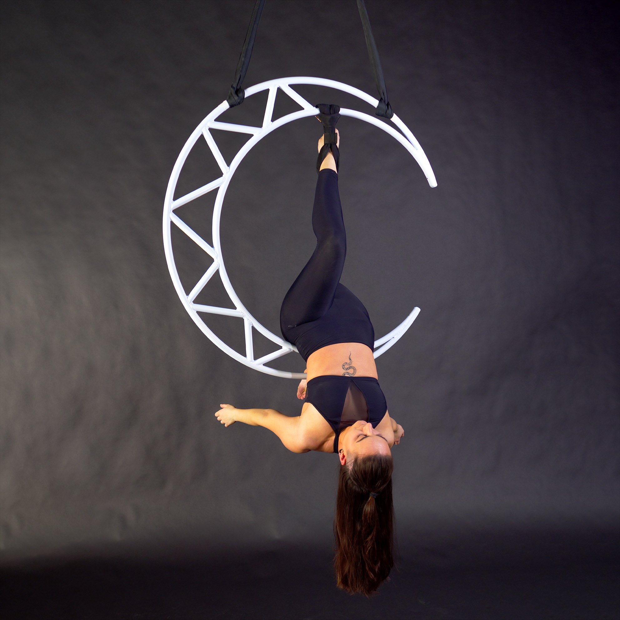 aerialist hanging from prop with hand loop