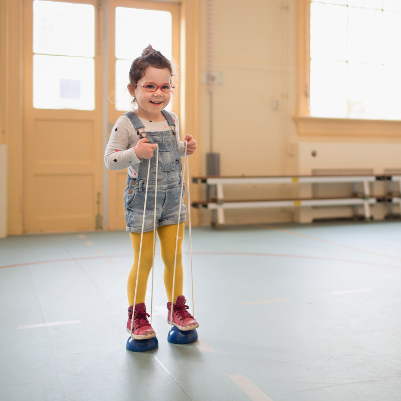 A child using wooden walking bobbins