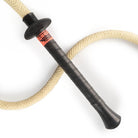 Gora fire whip handle laying on curled whip rope
