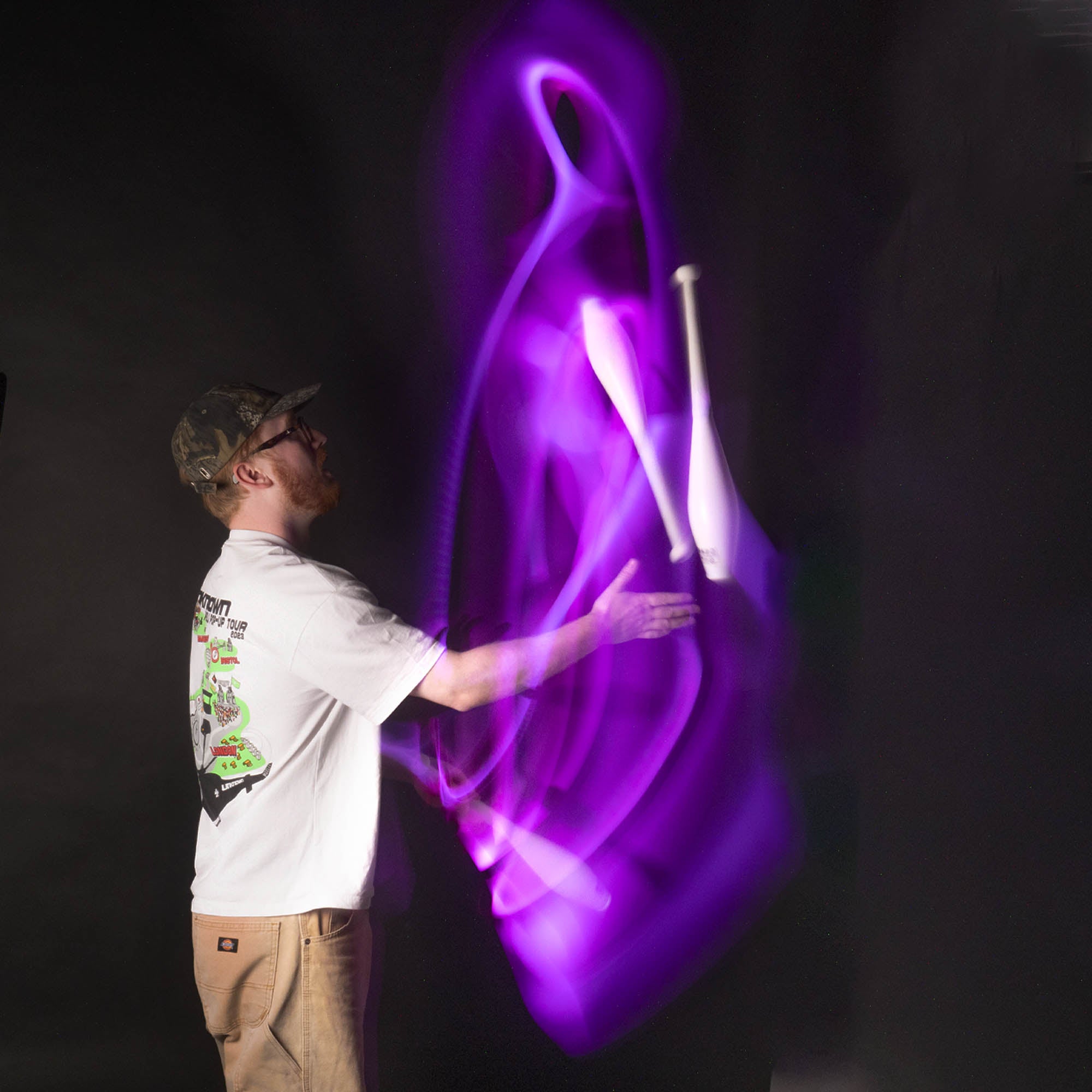 Nebula 3 LED juggling club action shot glowing purple 