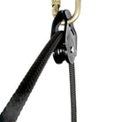 Petzl rescue pulley in black attached to carabiner rope pulling through