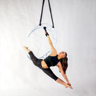 aerialist hanging from prop with hand loop